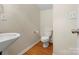 Half bath featuring a modern sink and toilet with a wood-look floor at 2137 Midnight Blue Ln, Fort Mill, SC 29708