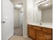 Bright bathroom features a wood vanity, large mirror, and an open door to the carpeted bedroom at 2137 Midnight Blue Ln, Fort Mill, SC 29708