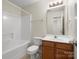 Bright bathroom featuring a shower-tub combo, vanity with light countertop and wood cabinetry at 2137 Midnight Blue Ln, Fort Mill, SC 29708