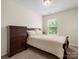 Bedroom with neutral carpet, light walls, window and dark wood dresser and bedframe at 2137 Midnight Blue Ln, Fort Mill, SC 29708