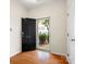 Bright entryway with hardwood floors, black front door with house number, and view of the exterior at 2137 Midnight Blue Ln, Fort Mill, SC 29708