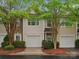 Inviting townhome exterior with attached garage, decorative stone accents, and mature trees at 2137 Midnight Blue Ln, Fort Mill, SC 29708