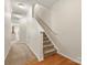 Hallway with carpet, wood trim, and staircase at 2137 Midnight Blue Ln, Fort Mill, SC 29708