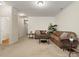 Large living room with neutral carpet, brown sofas, and decorative plants at 2137 Midnight Blue Ln, Fort Mill, SC 29708
