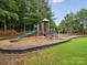 Community playground area with a slide, swing set and bench at 2137 Midnight Blue Ln, Fort Mill, SC 29708