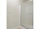 Glass door shower with tile base and neutral colored walls at 2137 Midnight Blue Ln, Fort Mill, SC 29708
