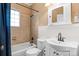 Bright bathroom with a tub, sink, and decorative mirror at 218 5Th Se St, Hickory, NC 28602