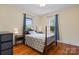 Cozy bedroom with hardwood floors, natural light, and neutral-toned walls at 218 5Th Se St, Hickory, NC 28602