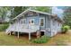 Blue home featuring a white porch and a small basement entrance at 218 5Th Se St, Hickory, NC 28602