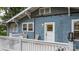 View of covered porch with white railings and chairs, set against the home's blue exterior at 218 5Th Se St, Hickory, NC 28602