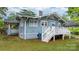 Rear exterior view with white porch, blue siding, and well-maintained yard at 218 5Th Se St, Hickory, NC 28602