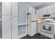 Charming kitchen with white appliances and cabinets, black and white backsplash at 218 5Th Se St, Hickory, NC 28602