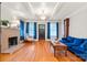 Inviting living room with a brick fireplace, hardwood floors, a grandfather clock, and a blue couch at 218 5Th Se St, Hickory, NC 28602