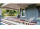 Inviting porch with swing, greenery, red floors, and gray railings at 218 5Th Se St, Hickory, NC 28602