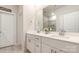 Bright bathroom featuring dual sinks, white cabinets, framed mirror, and large countertop at 2202 Cherrybark Ct, Denver, NC 28037