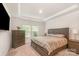 Cozy bedroom with a tray ceiling, large bed, and a window providing natural light at 2202 Cherrybark Ct, Denver, NC 28037