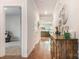 Inviting hallway with hardwood floors, console table, and neutral paint, leading to the living area at 2202 Cherrybark Ct, Denver, NC 28037