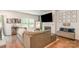 Comfortable living room with a fireplace, large TV, stylish decor, and hardwood floors at 2202 Cherrybark Ct, Denver, NC 28037