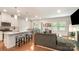 Open-concept living space with a sleek kitchen island, hardwood floors, and natural lighting at 2202 Cherrybark Ct, Denver, NC 28037