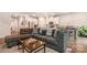 Open-concept living area featuring a large sofa, a coffee table, and an adjacent dining area at 2202 Cherrybark Ct, Denver, NC 28037