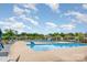 Community pool featuring a zero entry, blue umbrellas, and lounge seating at 2202 Cherrybark Ct, Denver, NC 28037