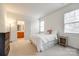 Bright bedroom with a cozy feel, featuring a window and adjacent bathroom access at 2235 Legacy Oak Dr, Waxhaw, NC 28173