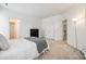 A well lit bedroom with carpet floors and a door leading to a bathroom at 2235 Legacy Oak Dr, Waxhaw, NC 28173