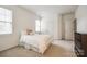 Neutral bedroom with soft natural light, carpeted flooring, and ample closet space at 2235 Legacy Oak Dr, Waxhaw, NC 28173
