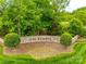 Welcoming stone entrance to The Reserve neighborhood with beautiful landscaping and signage at 2235 Legacy Oak Dr, Waxhaw, NC 28173