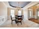 Elegant dining room with a coffered ceiling and a glass table at 2235 Legacy Oak Dr, Waxhaw, NC 28173