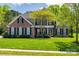 Traditional two-story brick home with manicured lawn and black shutters at 2235 Legacy Oak Dr, Waxhaw, NC 28173