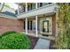 Inviting front porch with white columns and classic brick facade at 2235 Legacy Oak Dr, Waxhaw, NC 28173