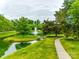 Scenic community pond with a fountain, walking path, and lush green surroundings, promoting relaxation at 2235 Legacy Oak Dr, Waxhaw, NC 28173