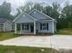 Charming single-story home featuring a welcoming front porch and a well-manicured lawn at 225 Baker St, Rock Hill, SC 29730