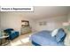 Well-lit bedroom featuring a comfortable chair, carpet flooring and pleasant decor at 3018 Sassafras Trl, Gastonia, NC 28056