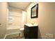 Bathroom featuring a tub, sleek vanity, framed mirror, and modern fixtures at 303 Nc Hwy 200 N Hwy, Stanfield, NC 28163