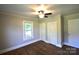 Bedroom with hardwood floors, neutral paint, a ceiling fan, and large window views at 303 Nc Hwy 200 N Hwy, Stanfield, NC 28163