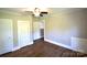 Bedroom showcasing hardwood floors, ceiling fan, closet, and neutral wall colors at 303 Nc Hwy 200 N Hwy, Stanfield, NC 28163
