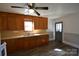 Eat-in kitchen features hardwood floors, classic wooden cabinets and natural light from the window at 303 Nc Hwy 200 N Hwy, Stanfield, NC 28163