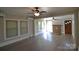 Spacious living room with hardwood floors, fireplace, and natural light from the windows at 303 Nc Hwy 200 N Hwy, Stanfield, NC 28163