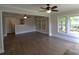 Bright living room featuring hardwood floors, neutral walls, and multiple ceiling fans at 303 Nc Hwy 200 N Hwy, Stanfield, NC 28163