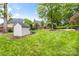 Backyard view with lush green lawn and a storage shed at 310 Whitestone Rd, Charlotte, NC 28270