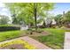 Well-maintained backyard with mature trees, a shed, and manicured garden beds at 310 Whitestone Rd, Charlotte, NC 28270