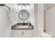 Bathroom with a round mirror, modern vanity with gray countertop, and brushed black fixtures at 310 Whitestone Rd, Charlotte, NC 28270