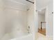 Bathroom showcasing a white tiled bathtub and shower with access to the hallway at 310 Whitestone Rd, Charlotte, NC 28270