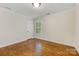 Bright bedroom featuring hardwood floors and natural light from the window at 310 Whitestone Rd, Charlotte, NC 28270