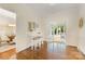 Inviting dining area features hardwood floors, and a sunroom with white framed glass doors at 310 Whitestone Rd, Charlotte, NC 28270