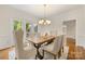 Elegant dining area with a wooden table, upholstered chairs, and access to the outdoor patio through French doors at 310 Whitestone Rd, Charlotte, NC 28270
