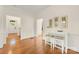 Cozy dining area featuring a wood floor, modern lighting and white trim with a small table and stools at 310 Whitestone Rd, Charlotte, NC 28270