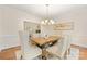 Bright dining room with a rustic wooden table, elegant chandelier, and comfortable upholstered chairs, perfect for Gathering gatherings at 310 Whitestone Rd, Charlotte, NC 28270